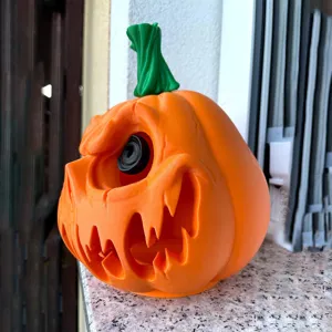 Halloween hollow pumpkin ornament detail, resin material with carved spooky face and green stem.