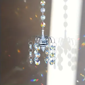 Crystal glass suncatcher detail showcasing prism facets and rainbow light reflections for decor.