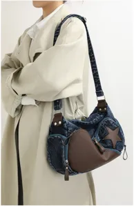 Stylish denim shoulder bag with brown leather accents and star detail, casual chic crossbody purse.