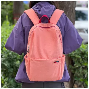 Detail view of a pink outdoor travel backpack showing capacity and water-repellent fabric.