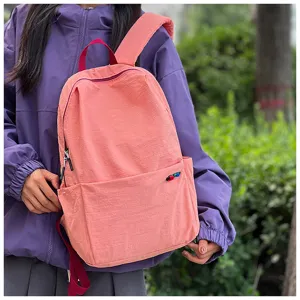 Detail view of the pink casual backpack featuring durable fabric, smooth zippers and front pocket.