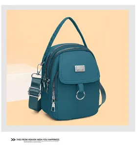 Blue multi-pocket casual crossbody bag, compact design with metal badge and adjustable strap.