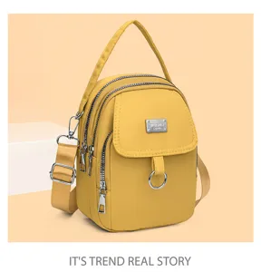 Detailed view of the yellow multi-zipper casual crossbody bag featuring convenient strap hardware.