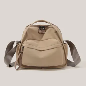 Khaki casual commuter crossbody bag with durable shoulder strap and dual zipper design.