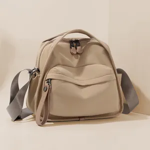 Detailed view of casual nylon crossbody shoulder handbag in beige, featuring multiple pockets.