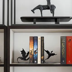 Detailed view of black metal dragon bookends on a modern bookshelf, decorative desk decor.