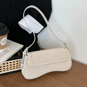 Vintage rivet shoulder bag for women, stylish niche design commuter armpit bag, chic daily use.