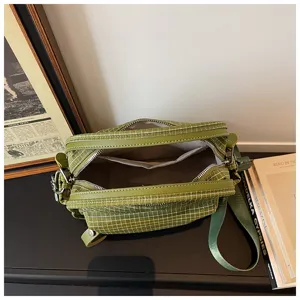 Green grid crossbody bag with zipper, casual shoulder bag with spacious interior compartment.