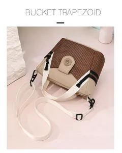 Detailed view of brown grid nylon bucket crossbody bag with white straps and chic design.