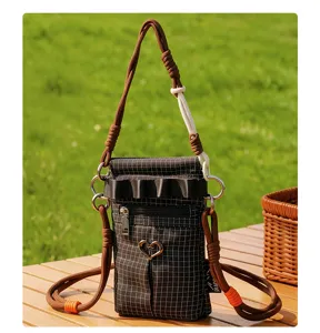 Vue détaillée du sac bandoulière à carreaux élégant avec sangle tressée et accessoires métalliques.