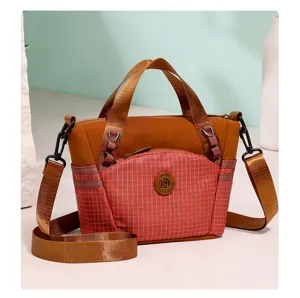 Stylish plaid small crossbody bag with durable fabric, front zippered pocket and sturdy handles.