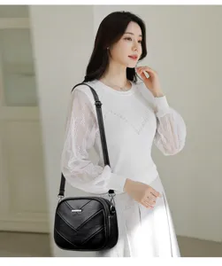 Stylish black leather shoulder bag with chevron texture, minimalist crossbody design for women.