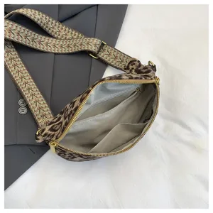 Leopard print crossbody chest bag, wide pattern strap, multi-pocket interior lining detail.