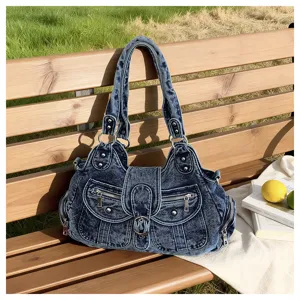 Vintage wash denim shoulder bag with multi-pockets, metal buckles and zippers for daily wear.