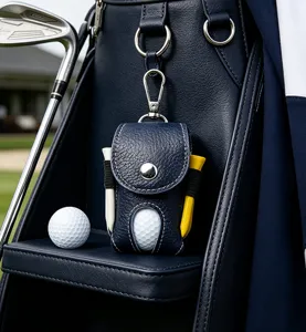 Detail view of genuine leather golf ball pouch with metal clip, tee holders, and golf ball.