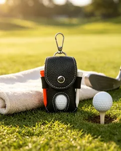 Detail view of genuine leather golf ball pouch with tees and clip on green grass course background