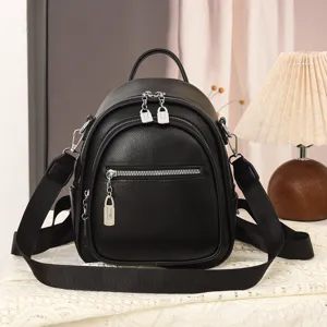Detailaufnahme des schwarzen weichen Lederrucksacks mit Reißverschlüssen und Anhängern.
