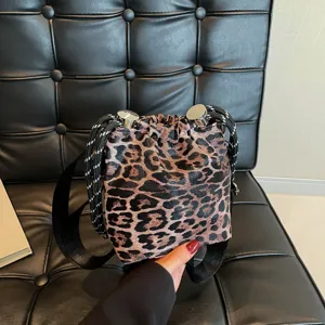 Leopard print bucket bag detail showing unique drawstring rope and metallic hardware.