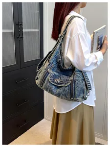 Y2K vintage distressed denim shoulder bag tote with metal star and multi-pocket motorcycle design.