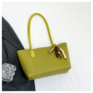 Green woven leather shoulder bag with wooden beaded charm, large capacity commuting tote handbag.