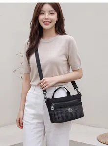 Fashionable lightweight black grid shoulder bag with comfortable strap for daily use and travel.
