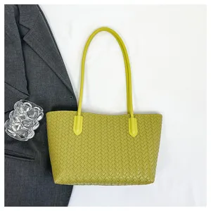 Detailed view of yellow green woven leather tote bag, perfect for daily commuting and office use.