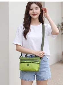 Green grid canvas crossbody bag for women, stylish lightweight shoulder bag with zipper.