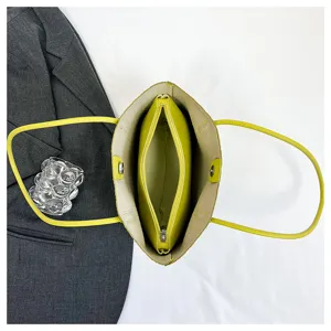 Top-down view of yellow tote bag with inner pouch, detailed interior structure and style.