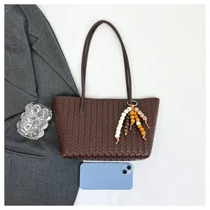 Dark brown woven leather tote bag with bead charm, stylish large capacity commuter shoulder bag.