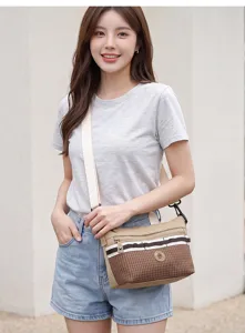 Close-up of casual crossbody bag with plaid pattern, adjustable strap and front zipper pocket.
