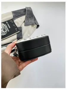 Guitar shaped crossbody bag with metal studs, unique black and white shoulder handbag Y2K.