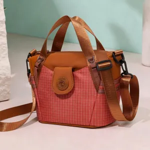 Trendy nylon crossbody bag in pink grid with top handle and brown straps for women main view
