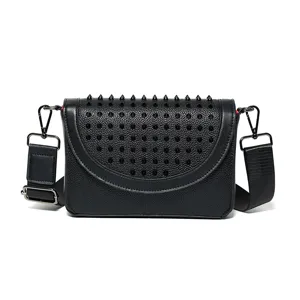 Black spiked leather crossbody bag for women, stylish designer shoulder bag with wide strap.
