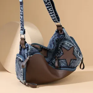 Stylish denim shoulder bag for women with brown leather contrast and chic star patch design.