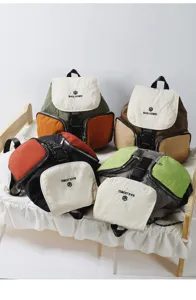 Detailed view of multi-color casual student backpack displaying contrast flap and storage.
