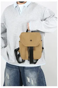 Detailed view of a trendy khaki grid small backpack, lightweight design for daily commute and travel.