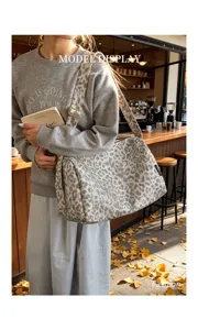 Leopard print canvas shoulder bag detail, casual large capacity tote with adjustable strap.