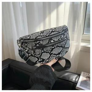 Detail view of a fashionable snake print crossbody chest bag with multi-zips and strap.