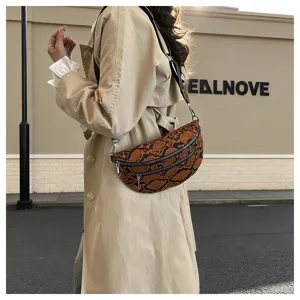 Detail showcase of the brown snake pattern crossbody dumpling bag with double zippers.