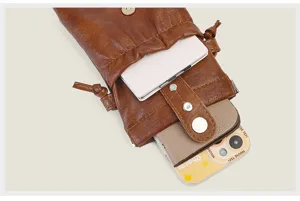 Brown PU leather drawstring mini phone bag, detail view showcasing interior storage design.