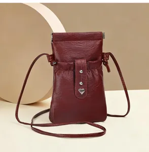 Minimalist wine red leather crossbody phone bag mini shoulder pouch with cute heart metal charm.