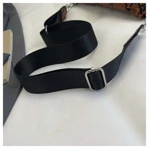 Adjustable black shoulder strap detail of stylish snake print women handbag for daily use.
