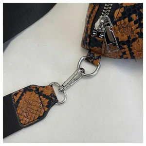 Detailed view of women crossbody shoulder bag strap hardware snakeskin texture close up