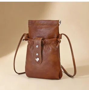 Brown PU leather crossbody phone bag, drawstring closure, heart charm detail, compact pouch.