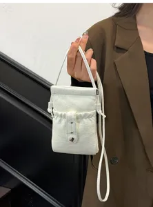 White leather phone pouch detail, mini crossbody bag with drawstring closure and metal heart.