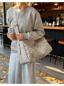 Stylish leopard canvas tote bag with adjustable strap, large capacity casual shoulder bag.