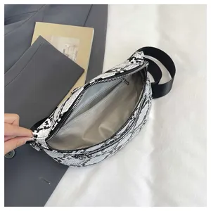 Detail view of trendy black and white snake print crossbody fanny pack with inner pocket.