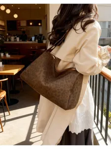 Detailed view of the stylish brown leopard print shoulder bag in a cozy cafe scene.