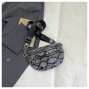 Stylish black and white snakeskin crossbody bag with wide strap and dual zippers.