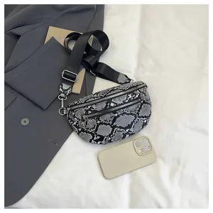 Detail view of a fashionable snake print crossbody bag with wide strap and dual zippers.